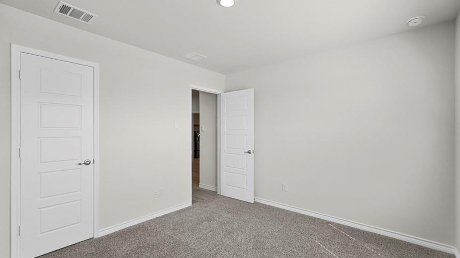 439 Epiphany Lane Lavon, TX 75166 - Photo 24 of 31 Neutral-toned room featuring a white interior door with horizontal paneling, soft gray carpeting, white baseboards, and a recessed ceiling light