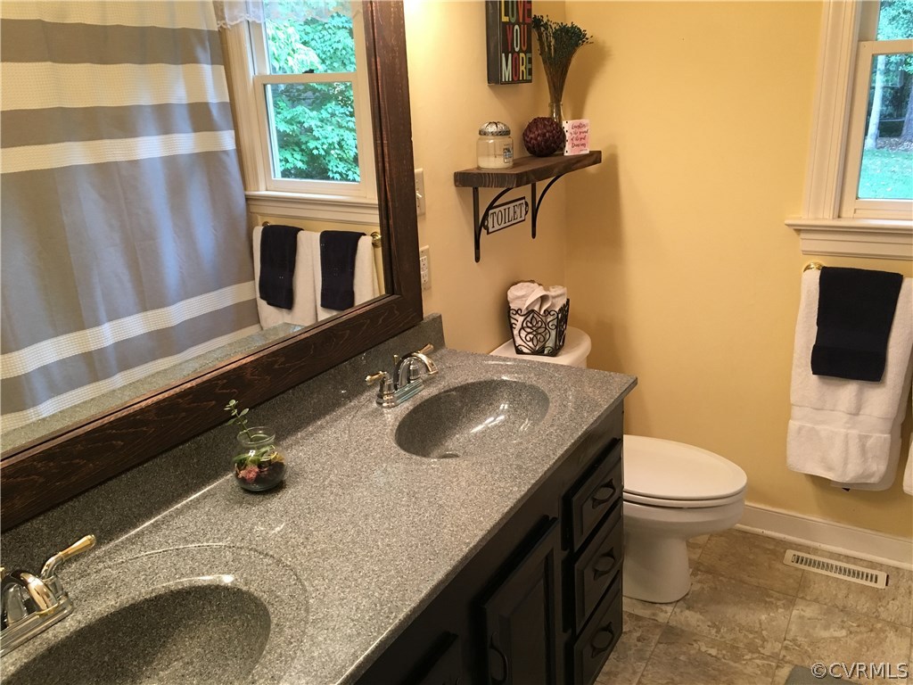 6007 Moss Creek Road Midlothian, VA 23112 - Photo 25 of 38 a bathroom with a granite countertop sink toilet and mirror