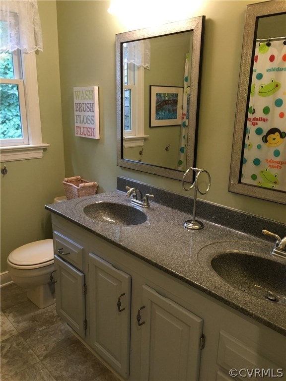 6007 Moss Creek Road Midlothian, VA 23112 - Photo 30 of 38 a bathroom with a granite countertop sink toilet and mirror