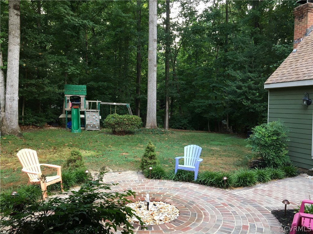 6007 Moss Creek Road Midlothian, VA 23112 - Photo 3 of 38 a view of a chair and table in the garden