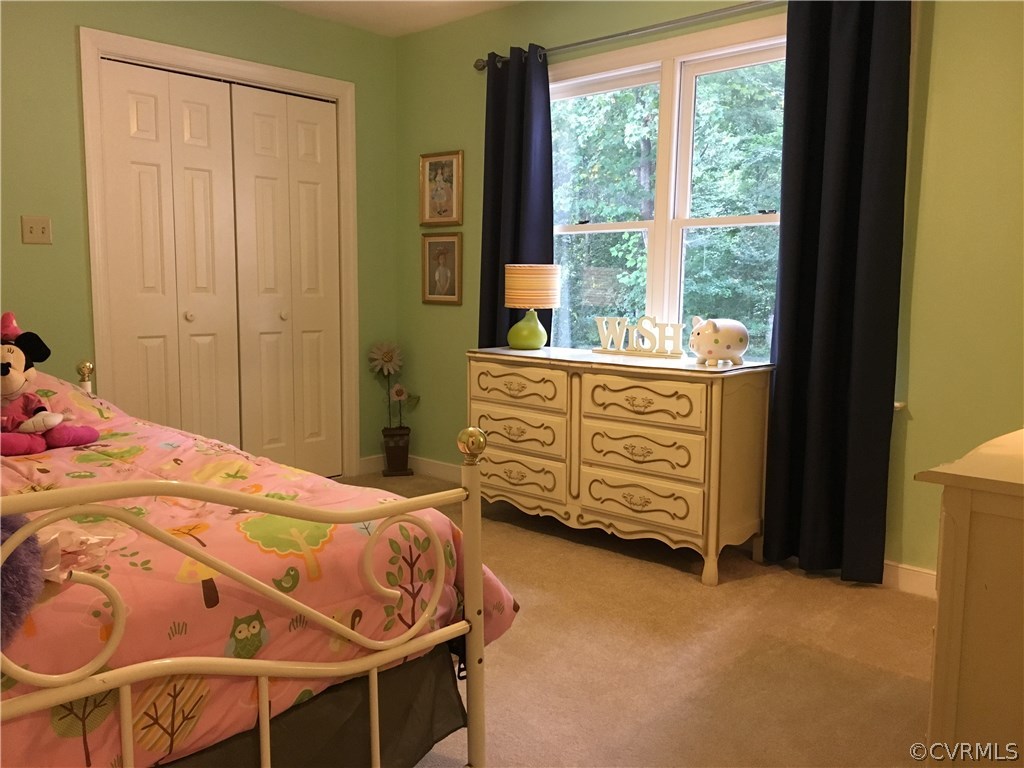 6007 Moss Creek Road Midlothian, VA 23112 - Photo 31 of 38 a bed sitting in a bedroom next to a window