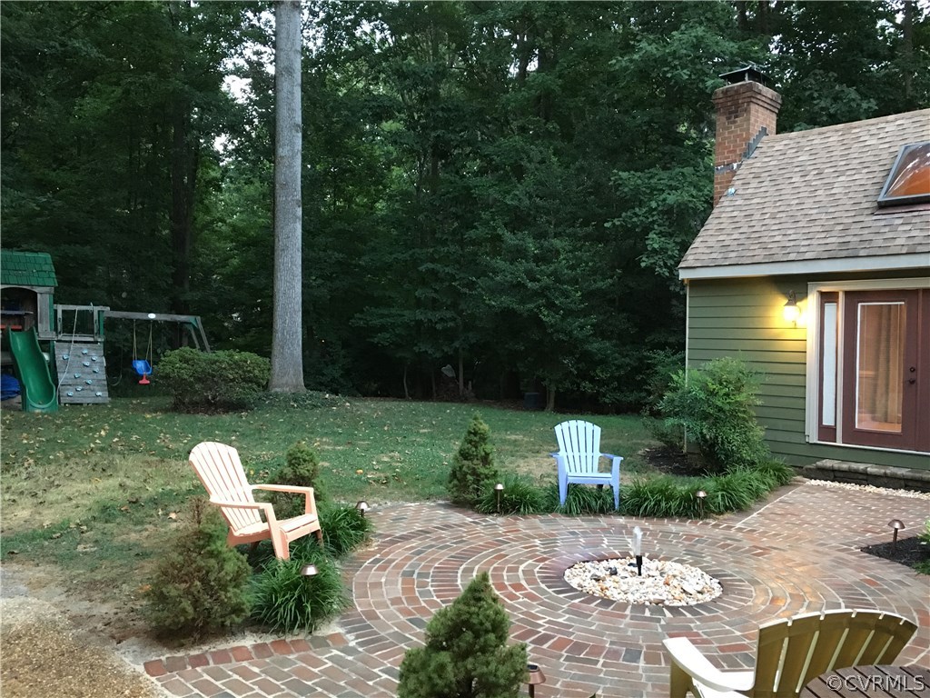 6007 Moss Creek Road Midlothian, VA 23112 - Photo 5 of 38 a view of a chair and table in backyard of the house