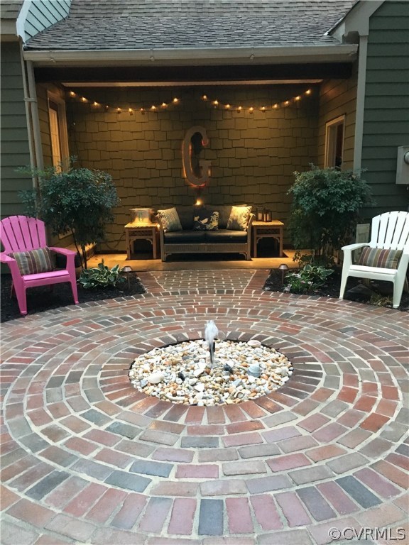 6007 Moss Creek Road Midlothian, VA 23112 - Photo 6 of 38 a view of a patio with table and chairs with wooden floor and a fireplace