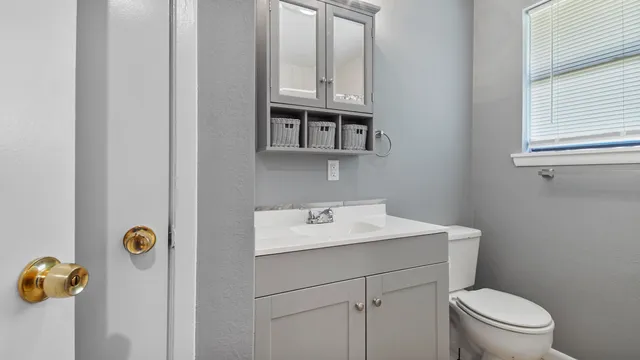 a bathroom with a sink toilet and vanity