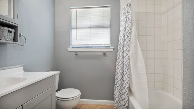 a bathroom with a toilet a sink and a shower