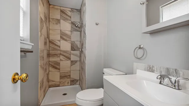 a bathroom with a sink toilet and shower