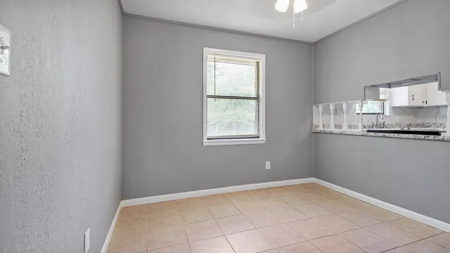 a view of a kitchen with wooden floor and a window
