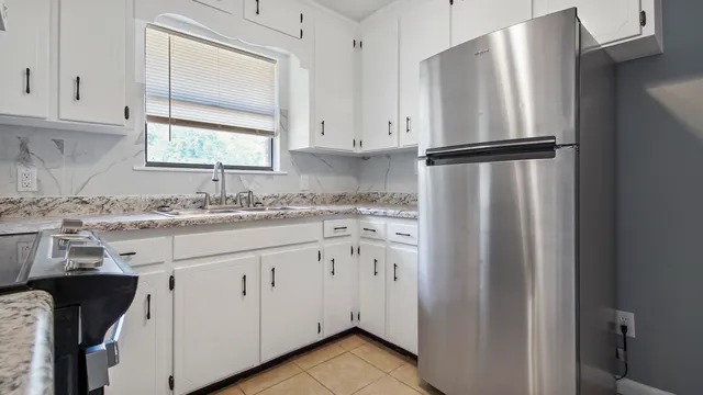 a kitchen with appliances cabinets and a sink
