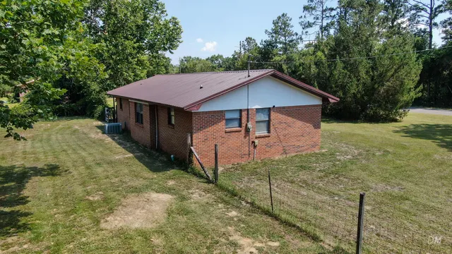 a backyard of a house with table and chairs