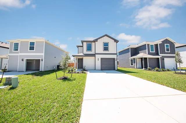 a front view of house with yard and car parked