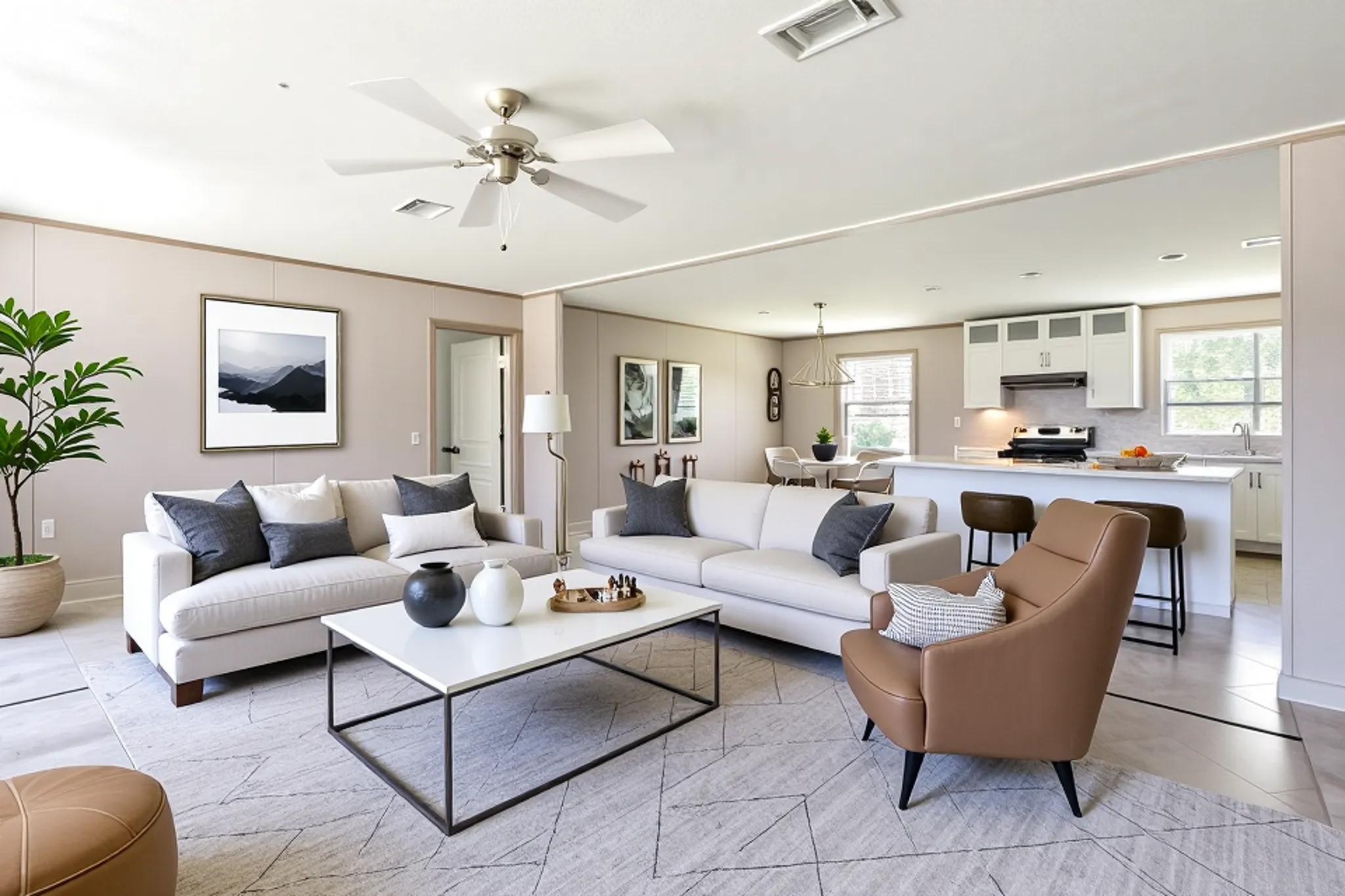 a living room with furniture kitchen view and a chandelier