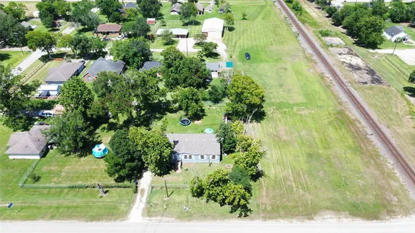 an aerial view of residential house with outdoor space and trees