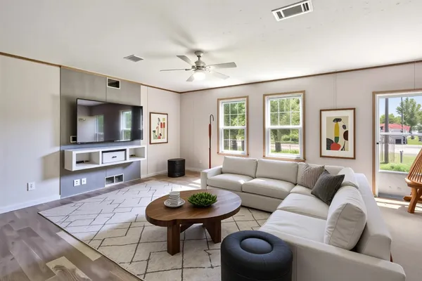 a living room with furniture and a flat screen tv