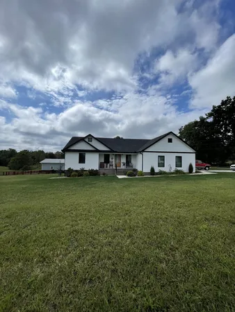 a front view of house with yard and green space