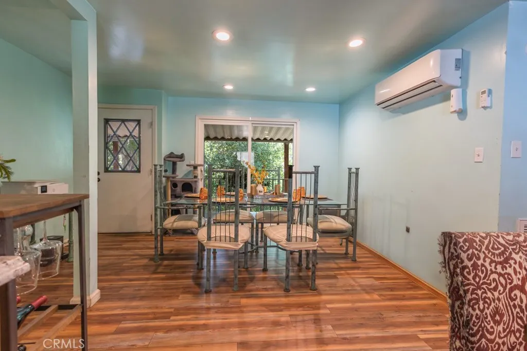 23500 The Old Road, Unit 35 Newhall, CA 91321 - Photo 11 of 43 a view of a dining room with furniture and wooden floor