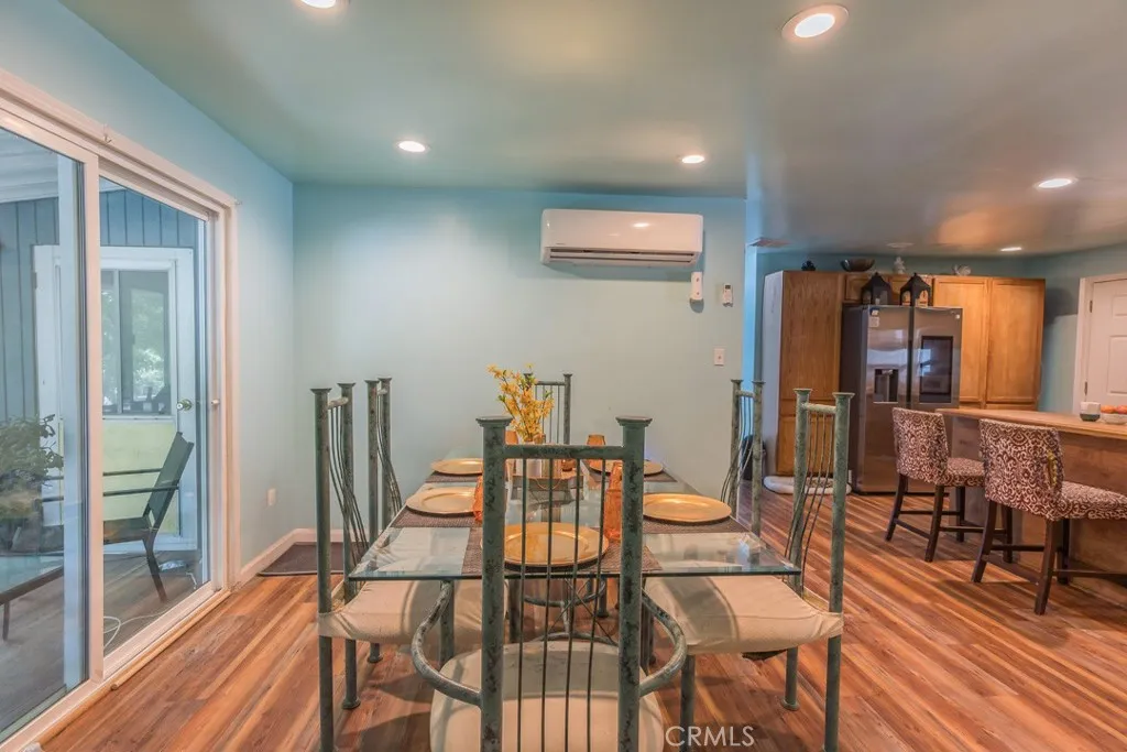 23500 The Old Road, Unit 35 Newhall, CA 91321 - Photo 12 of 43 a view of a dining room with furniture and wooden floor