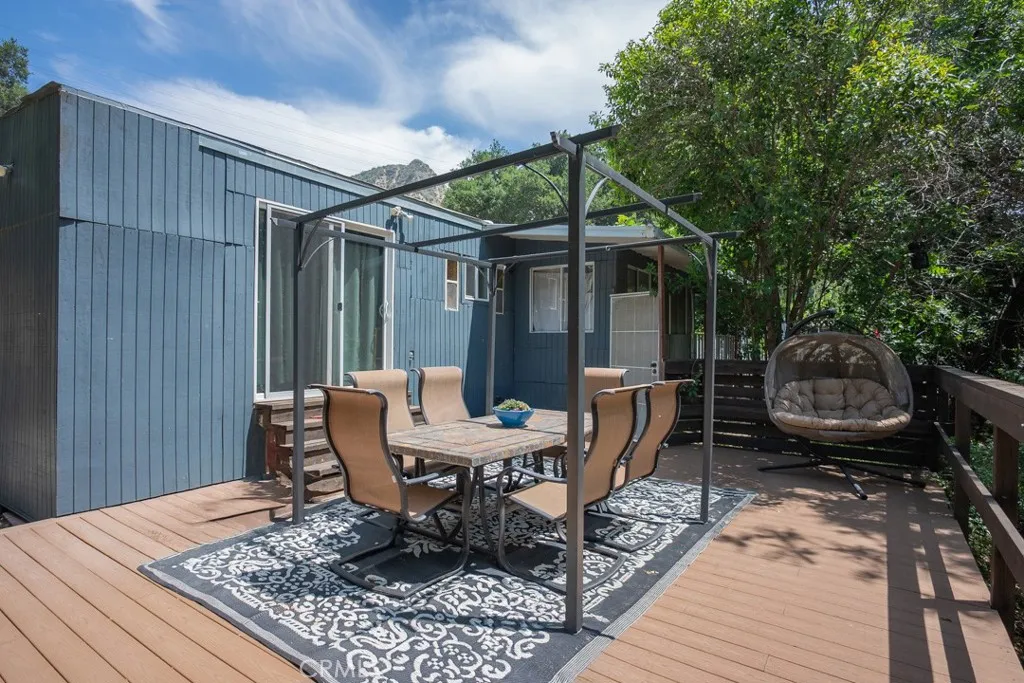 23500 The Old Road, Unit 35 Newhall, CA 91321 - Photo 29 of 43 a backyard of a house with barbeque oven table and chairs