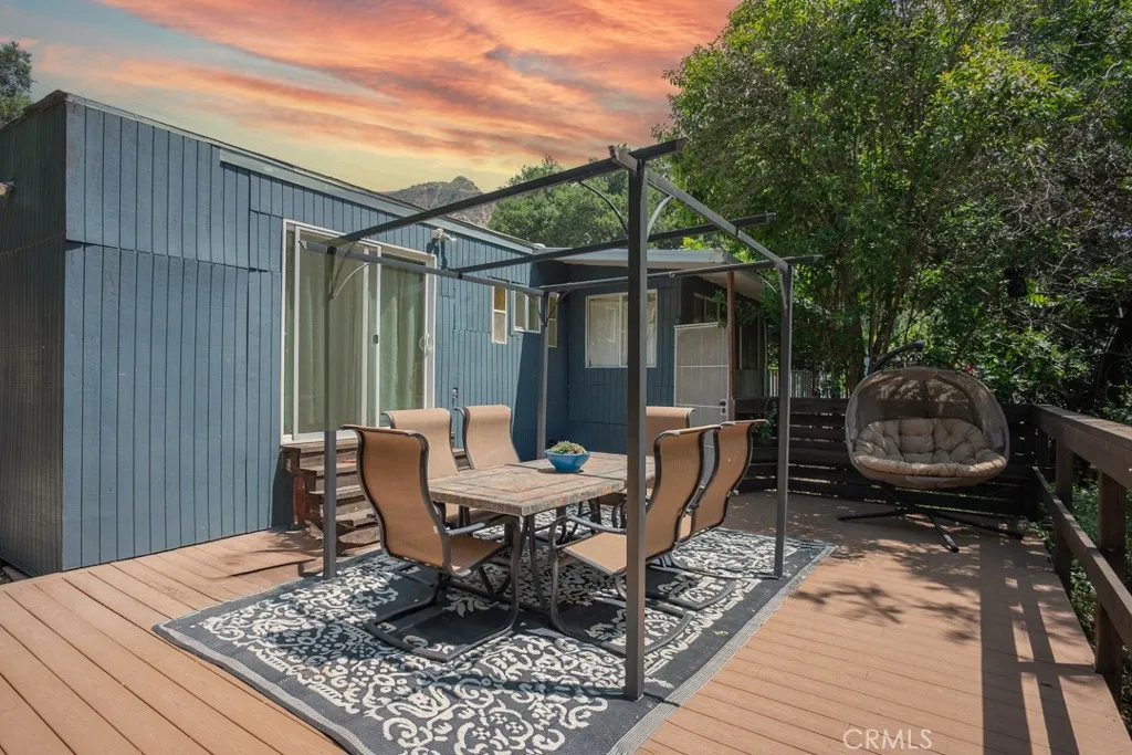23500 The Old Road, Unit 35 Newhall, CA 91321 - Photo 30 of 43 a backyard of a house with barbeque oven table and chairs