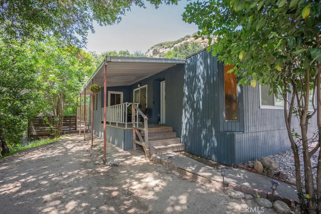 23500 The Old Road, Unit 35 Newhall, CA 91321 - Photo 37 of 43 a view of a house with porch and furniture