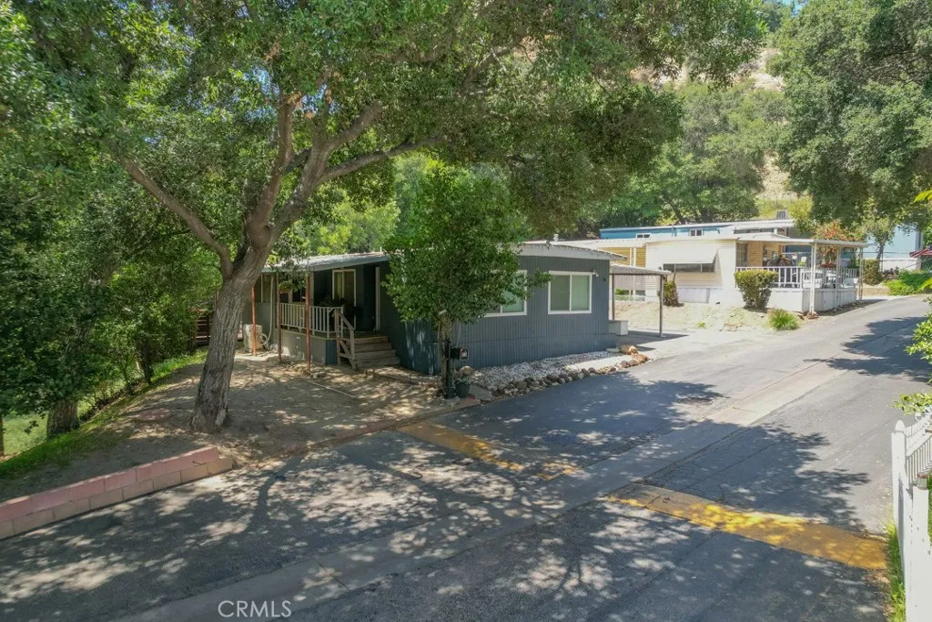 23500 The Old Road, Unit 35 Newhall, CA 91321 - Photo 42 of 43 a view of a house with backyard and a tree