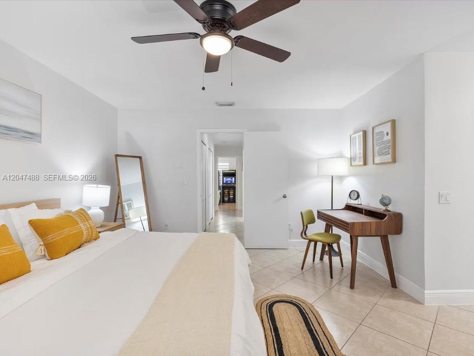 9840 Southwest 3rd Street Miami, FL 33174 - Photo 17 of 25 a bedroom with a bed and a desk