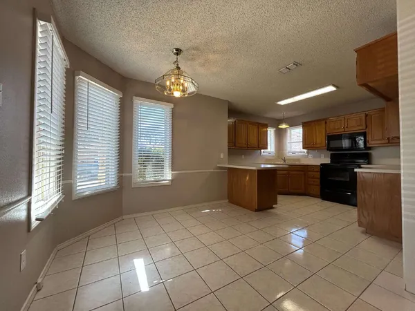 a large kitchen with cabinets and stainless steel appliances