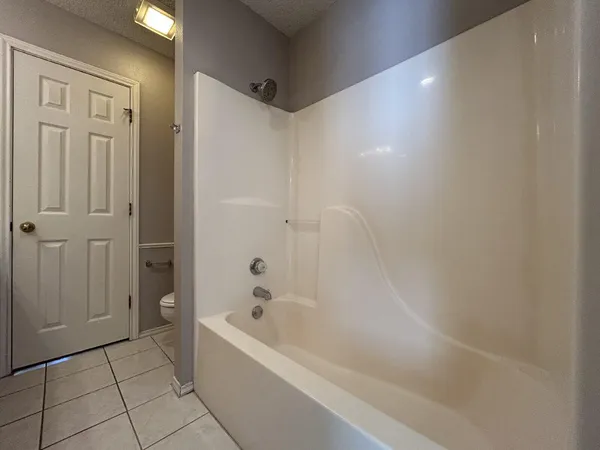 a bathroom with a bathtub and shower