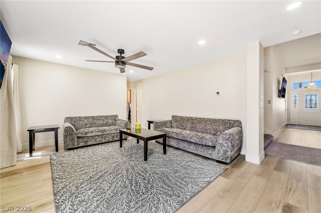 104 Appian Way Henderson, NV 89002 - Photo 7 of 24 Hardwood floors and recessed lighting elevate this inviting living space.