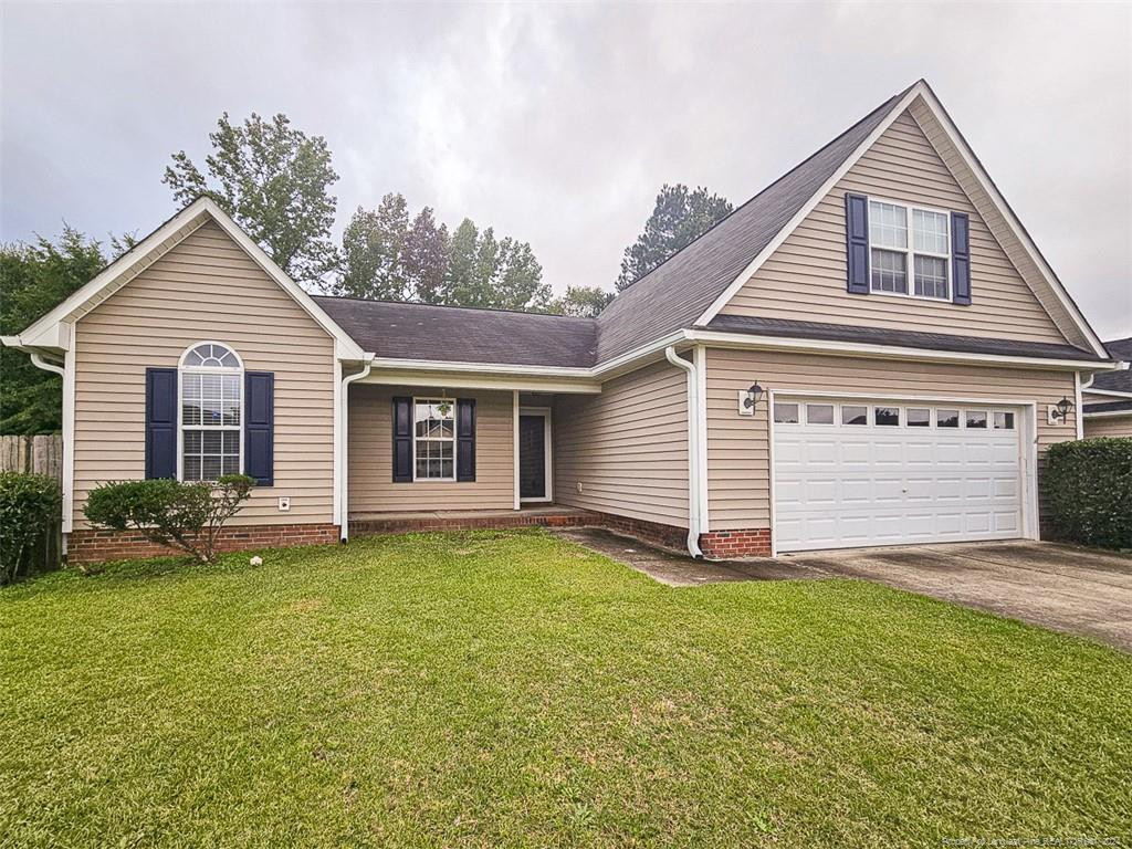 409 Sharpsburg Road Fayetteville, NC 28311 - Photo 2 of 7 a view of a house with a yard and garage