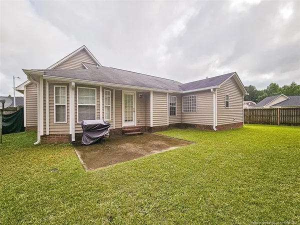 a view of a house with backyard porch and garden
