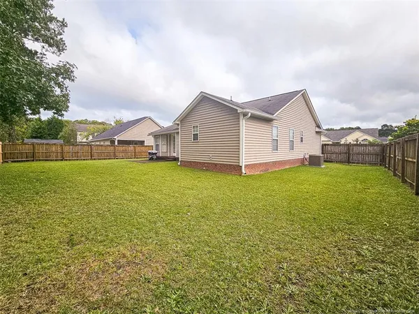 a view of a house with a yard and sitting area