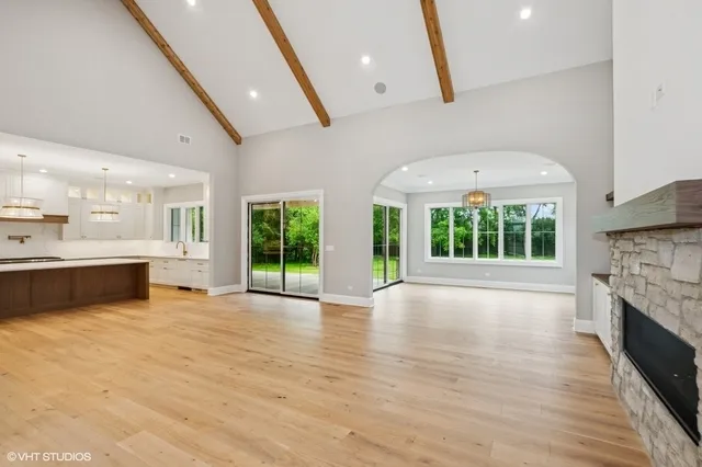 a view of an empty room with a fireplace and a large window