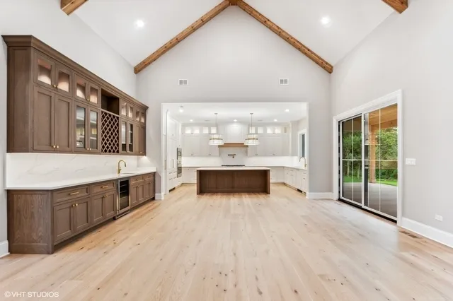 a large white kitchen with a large window