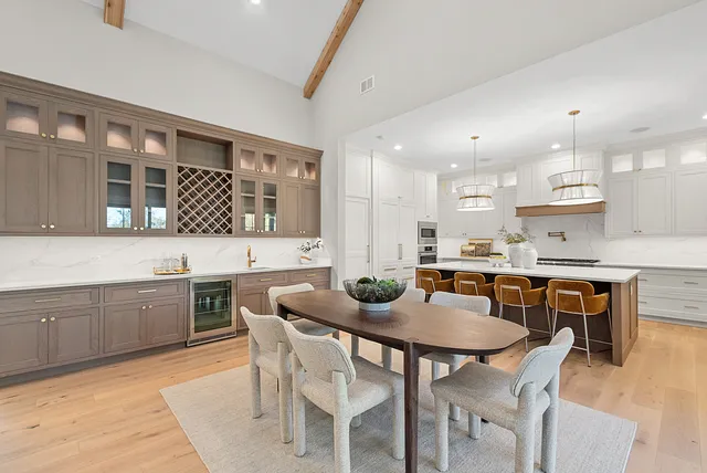 a kitchen with granite countertop a sink a center island and cabinets