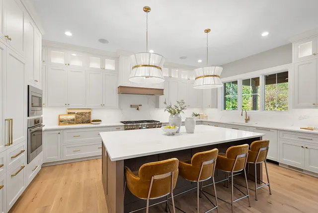 a kitchen with a table a stove and a refrigerator