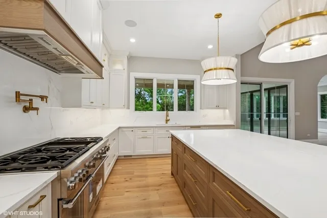 a kitchen with a stove and a wooden floors