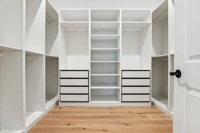 a view of walk in closet with empty racks