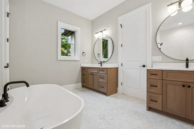 a bathroom with a sink double vanity and a mirror