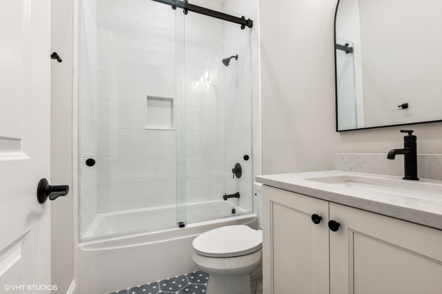 10940 German Church Road La Grange, IL 60525 - Photo 34 of 40 a bathroom with a granite countertop sink a toilet and shower