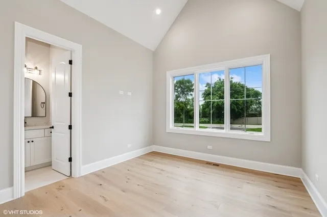 an empty room with a window and bathroom