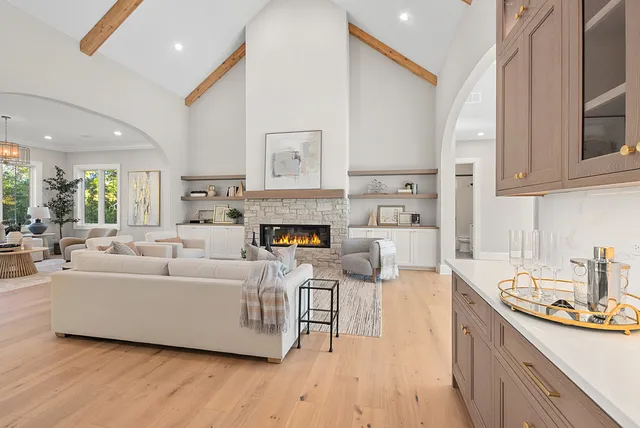 a living room with furniture large window and fireplace