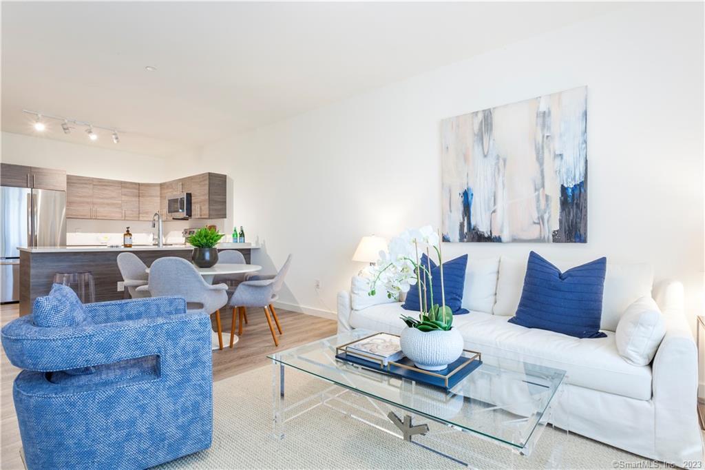 1675 Post Road, Unit 204 Fairfield, CT 06824 - Photo 1 of 1 a living room with furniture and a potted plant