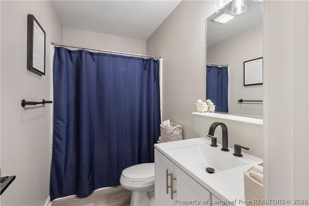 253 Farmstead Court Rockingham, NC 28379 - Photo 18 of 25 a bathroom with a sink toilet and vanity