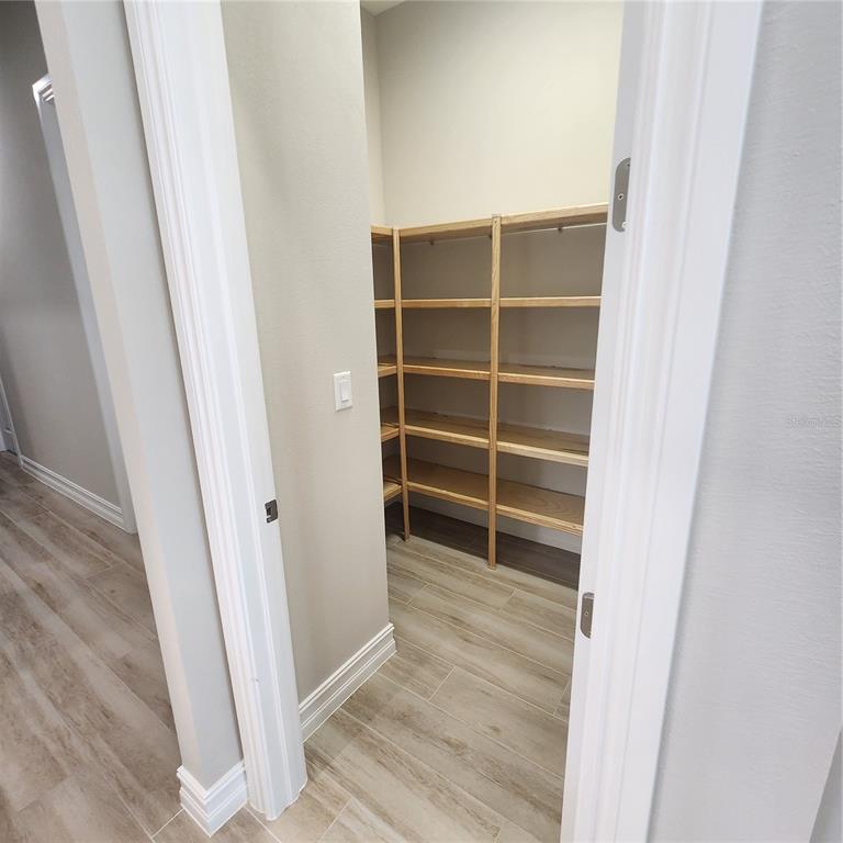 512 Blue Shell Loop Sarasota, FL 34240 - Photo 15 of 44 a view of walk in closet with empty racks