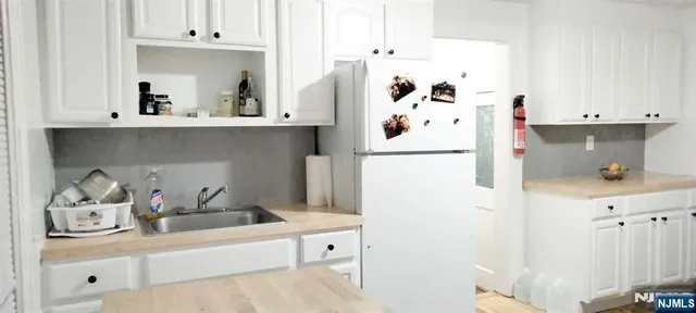 a kitchen with stainless steel appliances a refrigerator and a stove