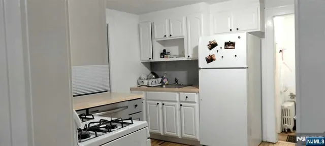 a kitchen with stainless steel appliances a refrigerator and a stove