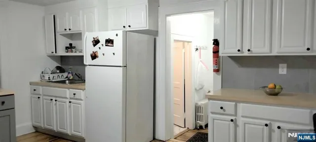 a white refrigerator freezer sitting in a kitchen
