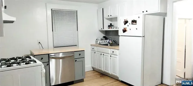 a kitchen with stainless steel appliances a refrigerator and a stove