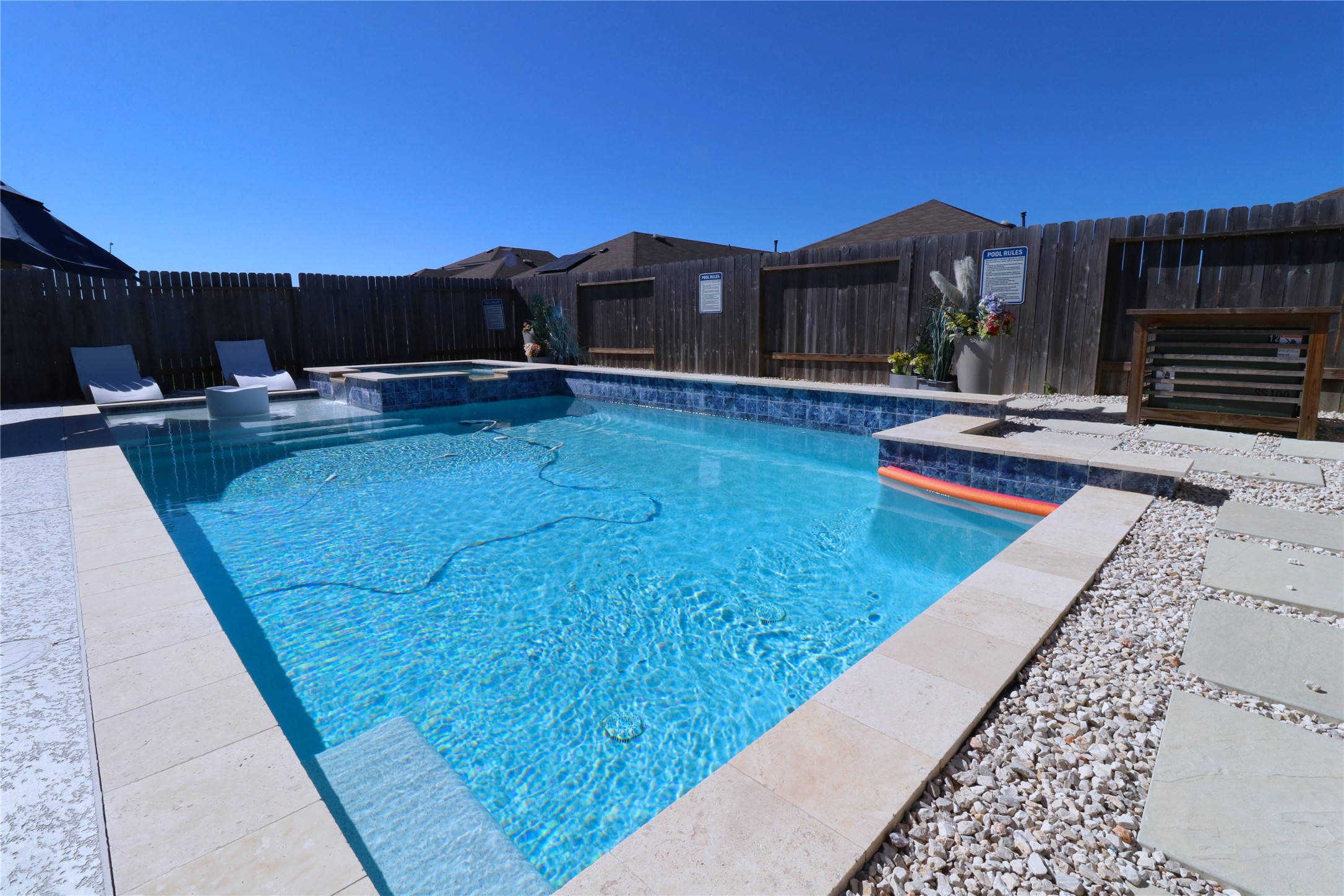 a view of swimming pool with a lounge chair