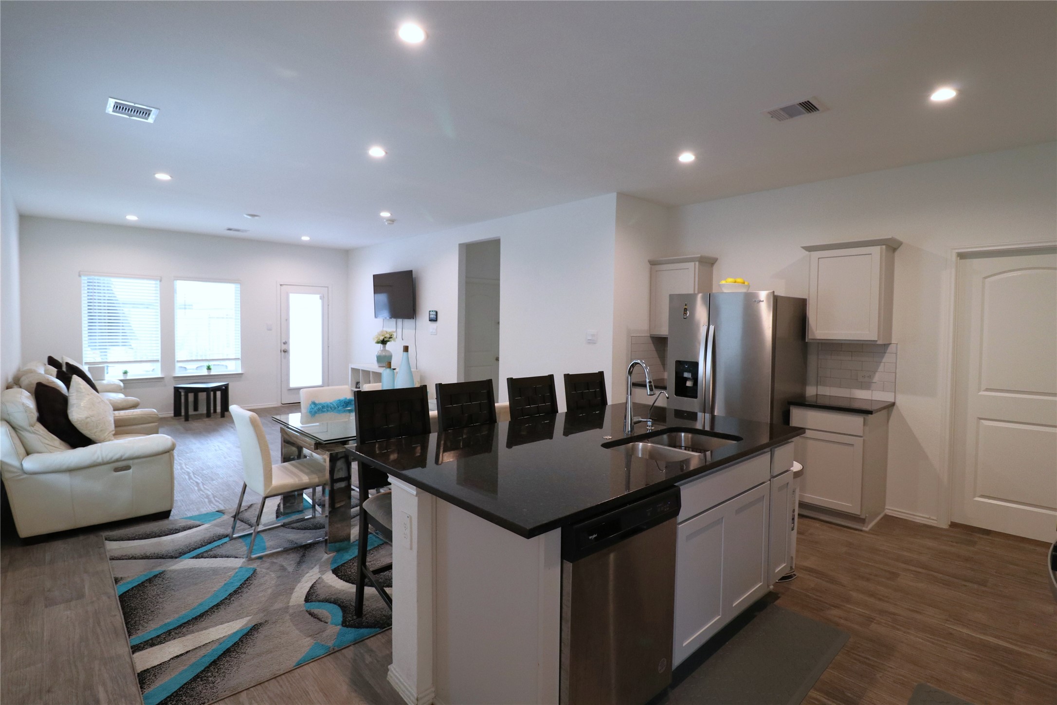 5415 Tuscany Hills Lane Spring, TX 77373 - Photo 3 of 18 a kitchen with counter space dining table stainless steel appliances and wooden floor